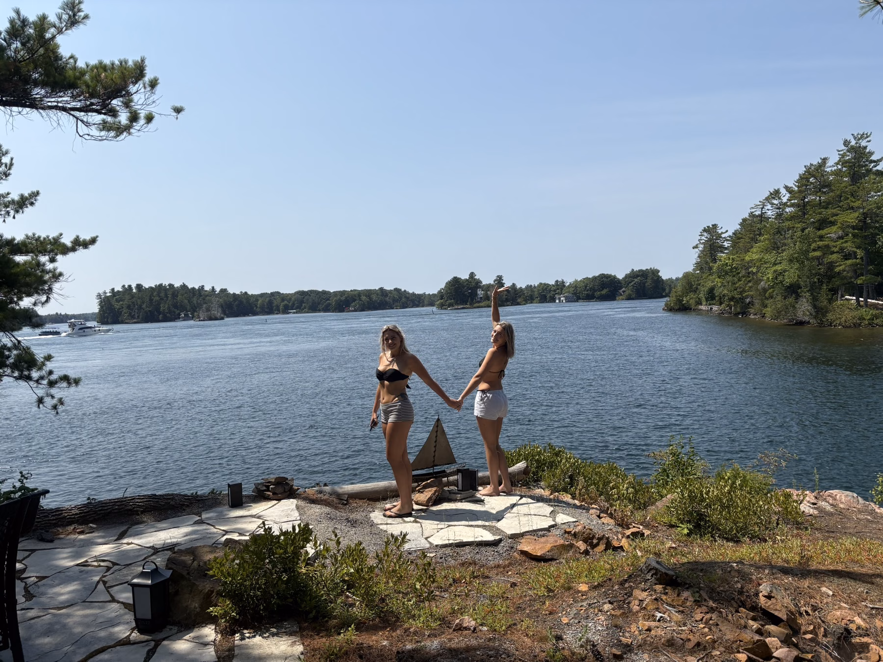 Two guests standing together on the island’s rocky shoreline